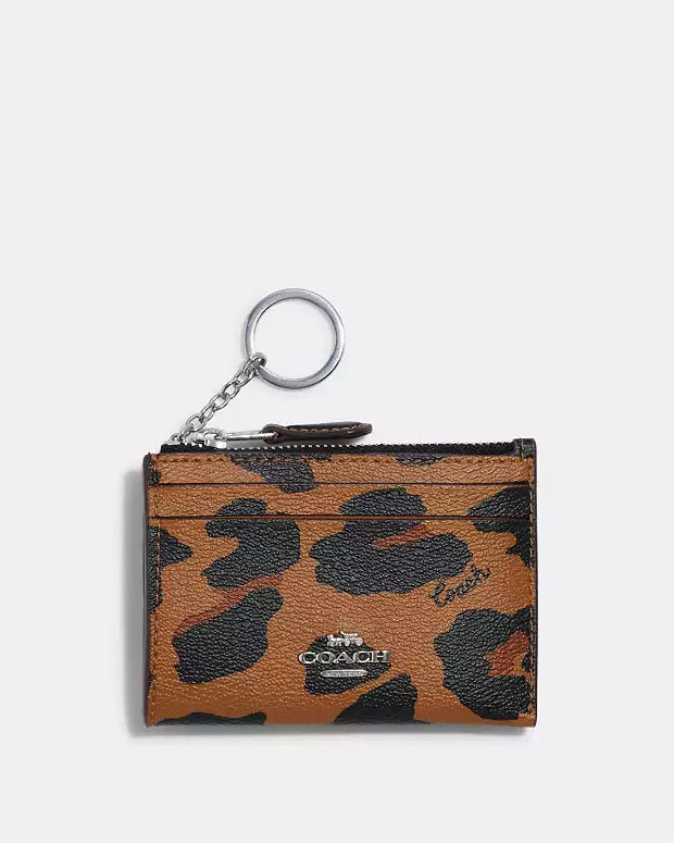 Coach tarjetero con cierre animal print